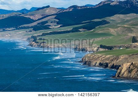 Castlepoint coastline showing farmland right up to the coastal cliffs.