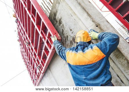 Worker disassemble falsework construction