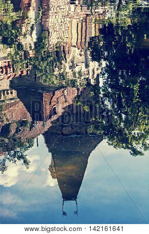 Beautiful Vajdahunyad castle is reflected in the water of the lake Budapest Hungary. Cultural heritage. Travel destination. Vertical composition. Famous place. Vintage photo filter. Architectural theme.