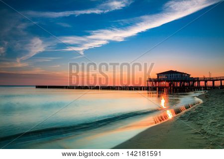 Restaurant at wooden pier on the baltic sea during sunrise. Ustronie Morskie Poland.