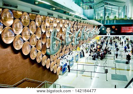 New Delhi India - Jule 20 2011: Passengers arrive at check-in counters at Indira Gandhi International Airport. Hands show the rack number of check-in. Mostly Indian people who illiterate.