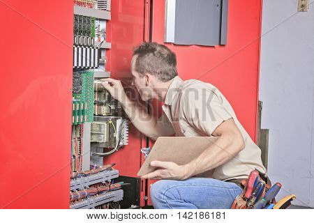 machinist worker technicians at work adjusting lift with spanners in elevator hoistway