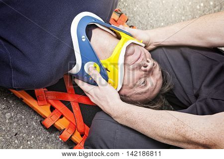A Paramedic employee help a person who have an accident.