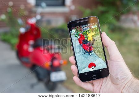 Montreal, Ca - August 10, 2016: Closeup Of A Man Playing Pokemon Go On A Smart Phone. Pokemon Go Is