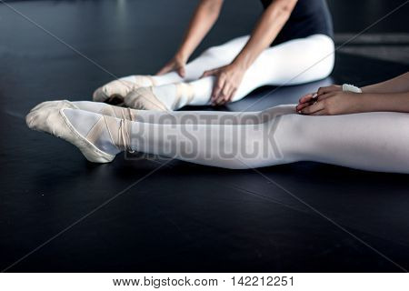 Young female dancers and their beautiful legs in the ballet shoes