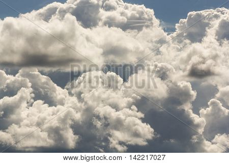 The mass of cumulus clouds.
Cumulus and cirrus clouds illuminated by the sun.