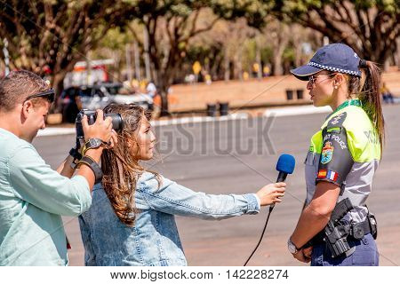 Brasilia, Brazil-August 4, 2016: Brazilian Police Officer Being Interviewed Outside the Mané Garrincha Stadium for the 2016 Rio Olympic Games