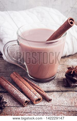 Hot cocoa with cinnamon sticks  on white background. Image tinted