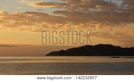 Sunrise scene at Totaranui Beach New Zealand. Golden sky.