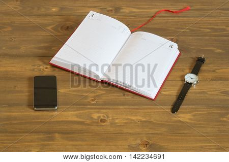 The book for records and hours with the phone on the table