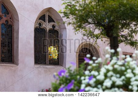 Sunlight shines through the stained glass windows of a church in Mittelbergheim Alsace