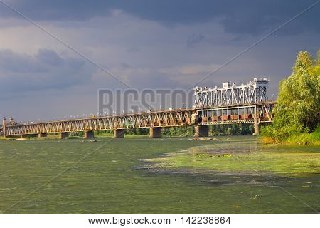 Bridge across river Dnieper in Kremenchug and storm clouds in sky