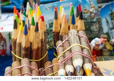 wood covered colorful pencils tied in bundles
