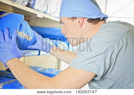 A men checking the inventory in a sterilizing place in the hospital.
