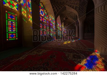 SHIRAZ IRAN - May 3 2016: Detail of the Nasir al Molk or Pink Mosque in Shiraz Iran. The stained glass windows produce a colourful effect on the carpets columns and walls in the morning.