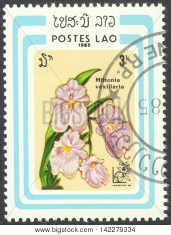 MOSCOW RUSSIA - CIRCA MAY 2016: a post stamp printed in LAOS shows Miltonia vexillaria orchid the series "International Stamp Exhibition Argentina '85 Buenos Aires Argentina - Orchids" circa 1985