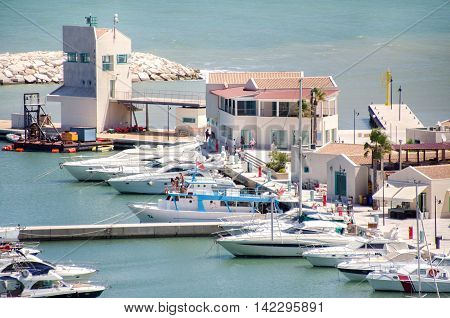 Rodi Garganico Italy August 2 2016: Boats moored at the marina and people that take a walk on the pier