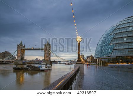 The iconic Tower Bridge with the City Hall building on an early winter morning - London, UK