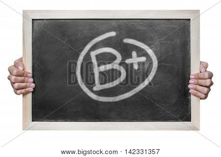 Woman hand hold grade b plus write on dirty blackboard isolated on white background