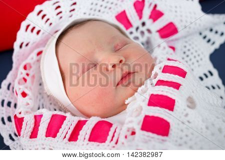 Newborn baby sleeping on a changing table