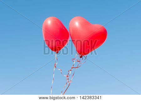 Valentine heart balloon against blue sky background