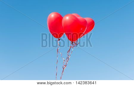 Valentine heart balloon against blue sky background