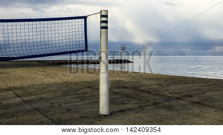 Beach area with rainbow beacon sculler and volley ball nets