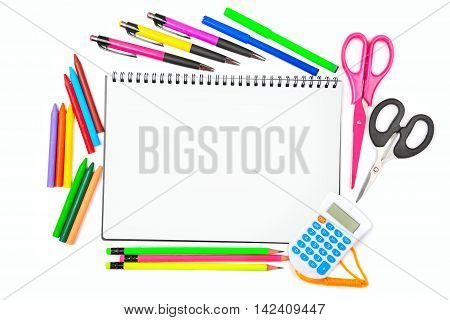 Notebook colored pencils crayons markers ballpoint pens and scissors isolated on white background