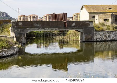Cagliari: small bridge over water channels within the Regional Park of the pond Molentargius - Sardinia