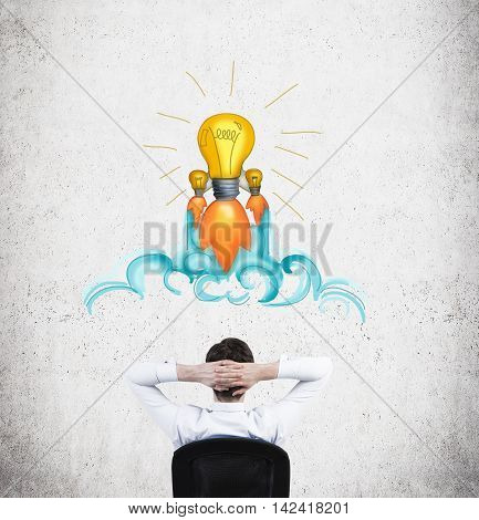 Businessman sitting in armchair with his back to camera in front of concrete wall with light bulb sketch on it thinking about business development. Concept of decision making and coming to conclusion