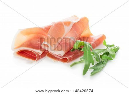 Sliced of jamon with aragula leaves isolated on white background