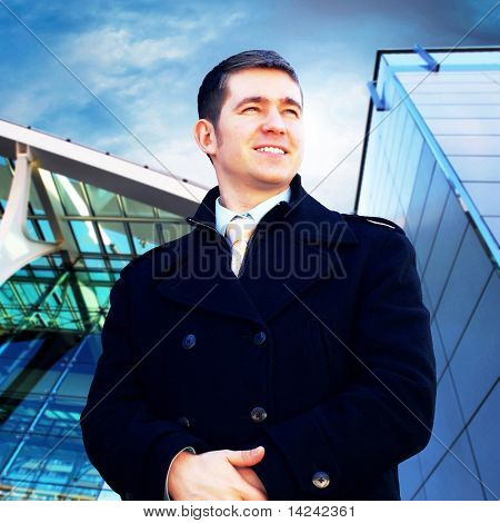 Homme d'affaires de bonheur sur le fond d'architecture d'entreprise