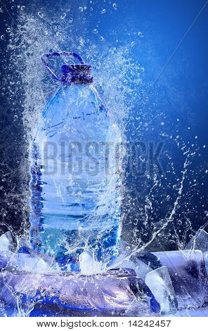 Buttle of water on the ice. Splash of water
