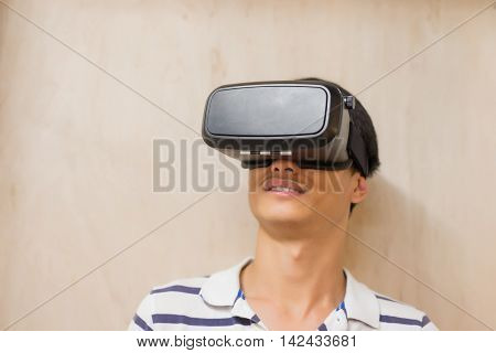 man wear virtual reality headset happily with Brown wall asian