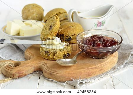 Pumpkin scones with dried fruit for breakfast served with jam and butter