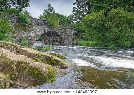 The River Brathay flows under Skelwith Bridge near Ambleside in the Lake District National Park, Cumbria, England a popular area for tourists.