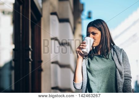 Girl With A Take-away Coffe Shopping