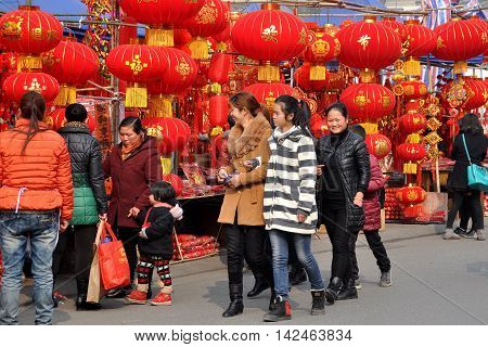 Pengzhou China - January 23 2014: People shopping for Chinese Lunar New Year decorations at the Long Xing outdoor marketplace