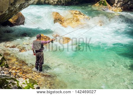 A Fly Fisherman Fishing In A River