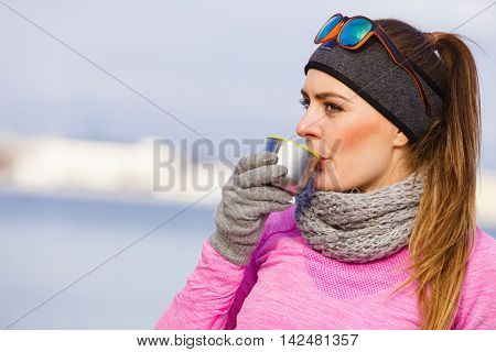 Fit Woman In Cold Day Warming Up Drink Tea