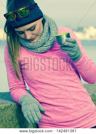 Fit Woman In Cold Day Warming Up Drink Tea