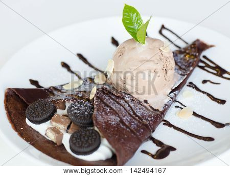 Crape chocolate and chocolate ice cream with topping chocolate and whippping cream.