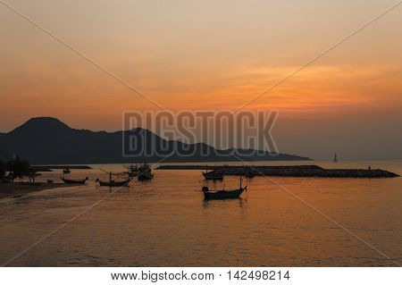 Boat on the beach at sunrise time Long-tail boatBoat fishermen waiting sea fishing : Soft focus due to long exposure shot.