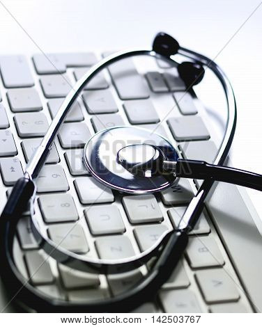 Selective focus of a computer keyboard and medical stethoscope. It-support.