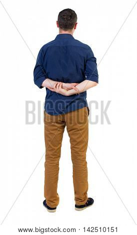 Back view of man . Standing young guy. Rear view people collection.  backside view of person.  Isolated over white background. a man in a blue shirt with the sleeves rolled up, standing with hands