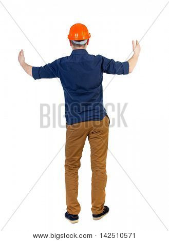 Back view of builder in helmet shows thumbs up.   Rear view people collection.  backside view of person.  Isolated over white background. The engineer in a blue shirt with the sleeves rolled up and a