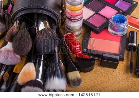 Paints, brushes and other makeup tools on the table.