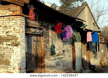 Pengzhou China - February 1 2007: Laundry dries in front of old brick houses on Hua Lu