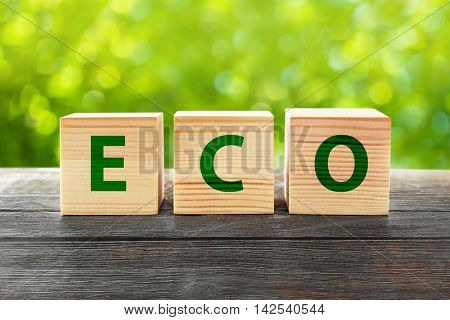 Word eco on wooden blocks. Ecological concept.