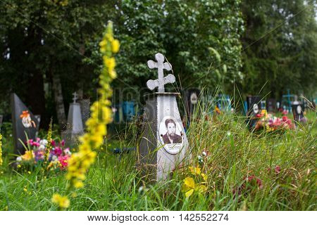SOGINICY, RUSSIA - JUL 30, 2016: Cemetery on site of Church of Nichola. Church of St. Nicholas at Soginicy, the only surviving sample of a steepled Church prionezhskiy school, 1696 built.